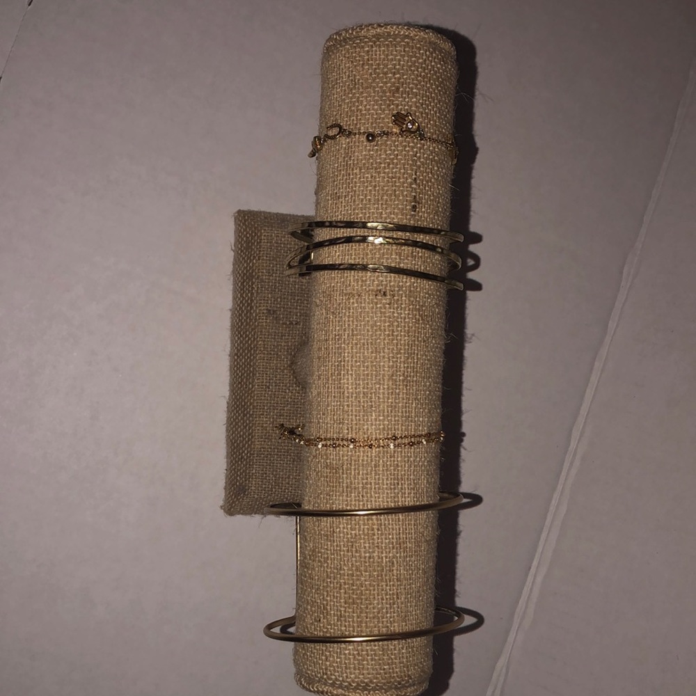 4 Gold bracelets from Anthropologie. Tan bracelet holder included with sale.